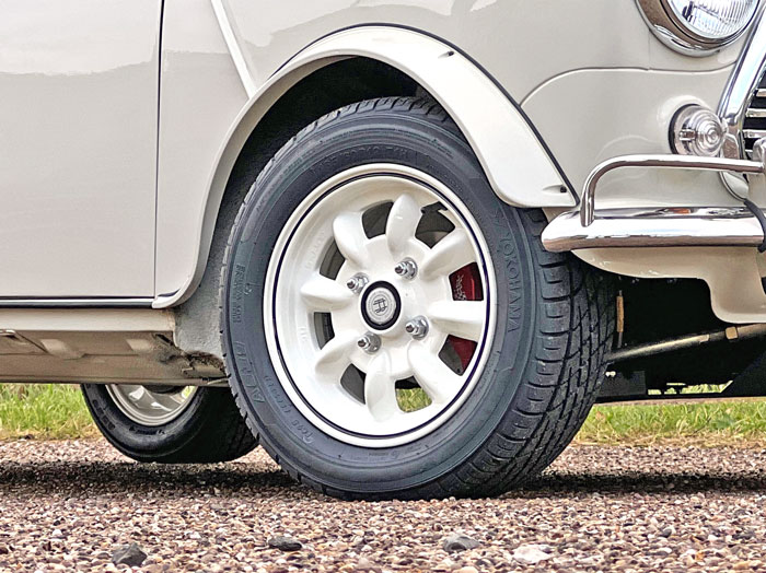 Meticulously crafted 12" wheels, painted in old English White with a Black Pin Stripe.