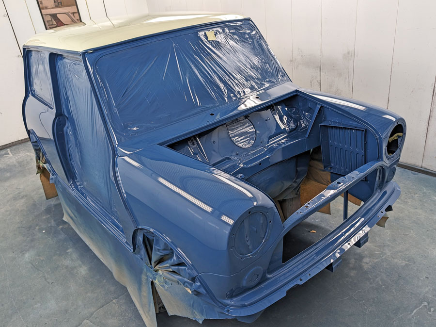 Freshly painted Mini Cooper shell in Island Blue and Snowberry white ready for a rebuild.